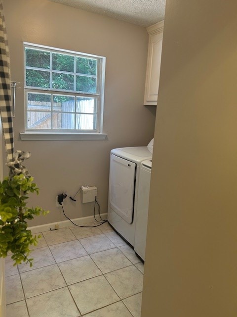 1699 Pin Oak Dr Unit 133, Dalton, GA 30721 - laundry area featuring independent washer and dryer, cabinet space, a textured ceiling, light tile patterned floors, and baseboards