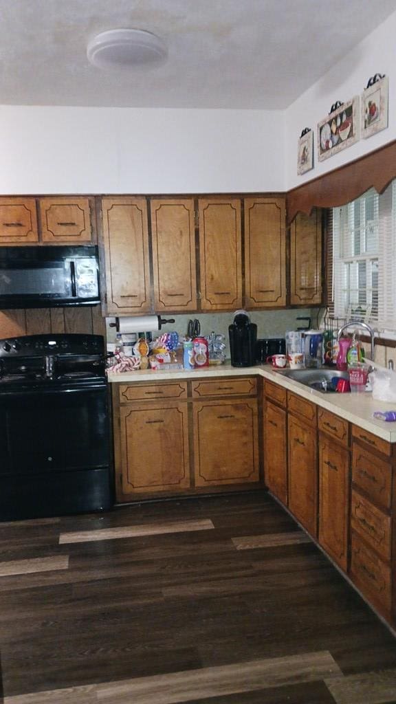 430 Lester Ave, Dalton, GA 30721 - kitchen featuring black appliances, light countertops, brown cabinetry, and dark wood finished floors
