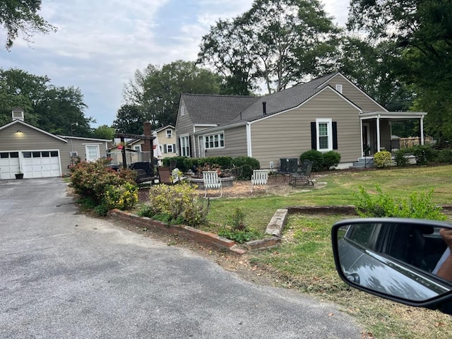 430 Lester Ave, Dalton, GA 30721 - view of front of home with an outbuilding, a garage, and a front yard