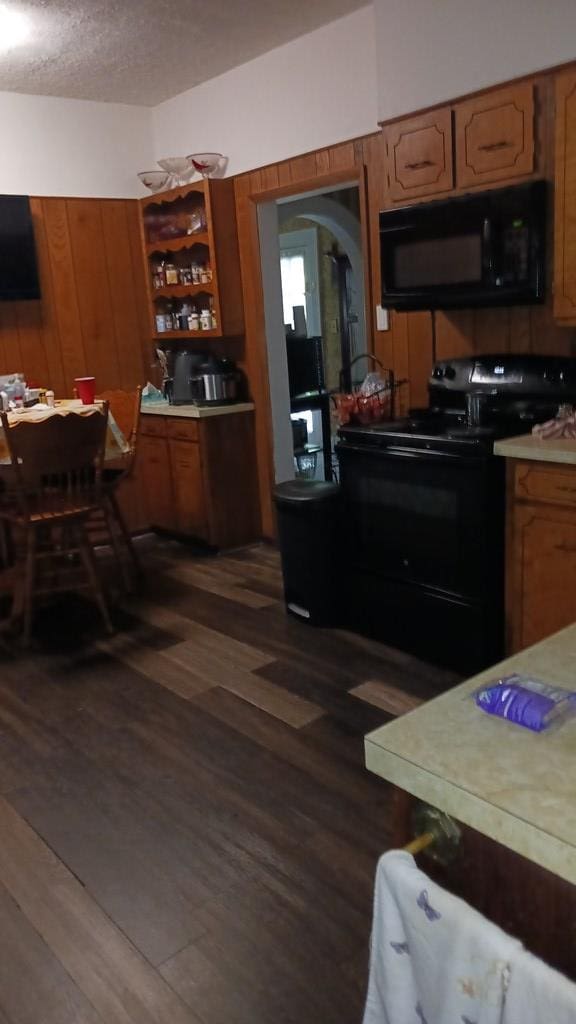 430 Lester Ave, Dalton, GA 30721 - kitchen with black appliances, brown cabinets, and dark wood-style flooring