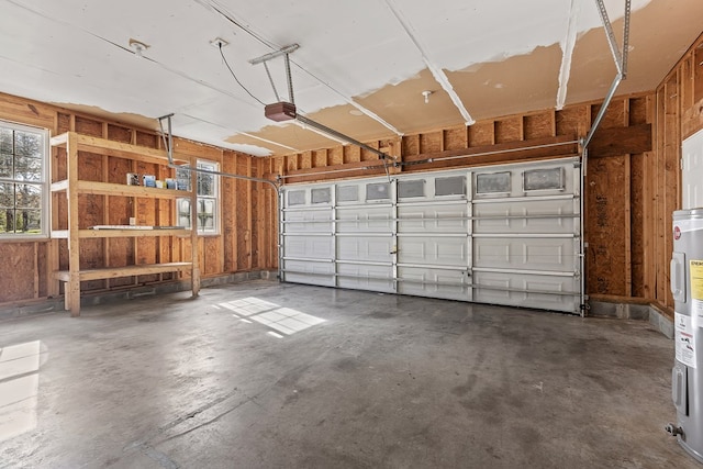 garage featuring a garage door opener and electric water heater