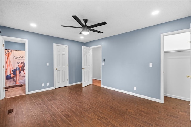 493 Lennox Way, Rocky Face, GA 30740 - unfurnished bedroom with baseboards, recessed lighting, a walk in closet, and dark wood-style flooring