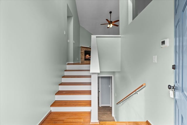 493 Lennox Way, Rocky Face, GA 30740 - stairs with wood finished floors, a ceiling fan, baseboards, and a towering ceiling