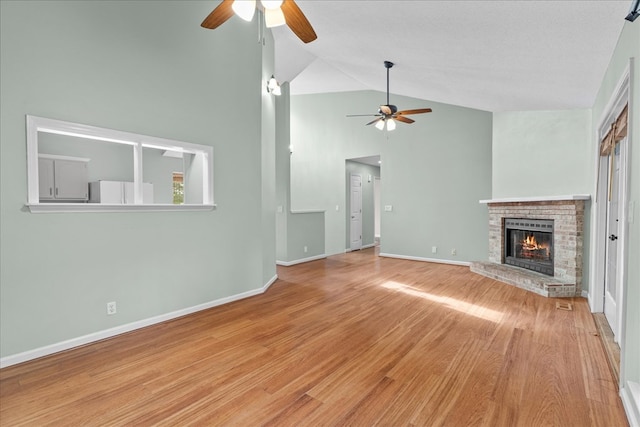 493 Lennox Way, Rocky Face, GA 30740 - unfurnished living room featuring high vaulted ceiling, a ceiling fan, wood finished floors, a fireplace, and baseboards