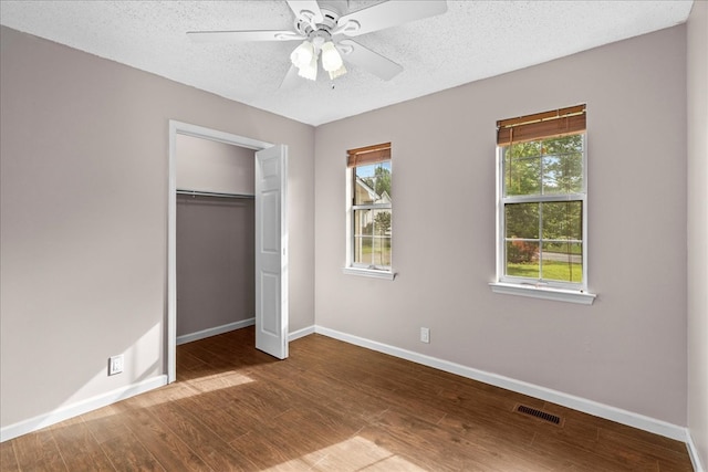 493 Lennox Way, Rocky Face, GA 30740 - unfurnished bedroom featuring wood finished floors, visible vents, a closet, baseboards, and a textured ceiling
