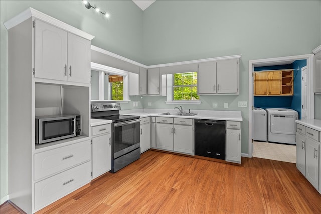 493 Lennox Way, Rocky Face, GA 30740 - kitchen with a sink, washer and clothes dryer, light countertops, high vaulted ceiling, and appliances with stainless steel finishes