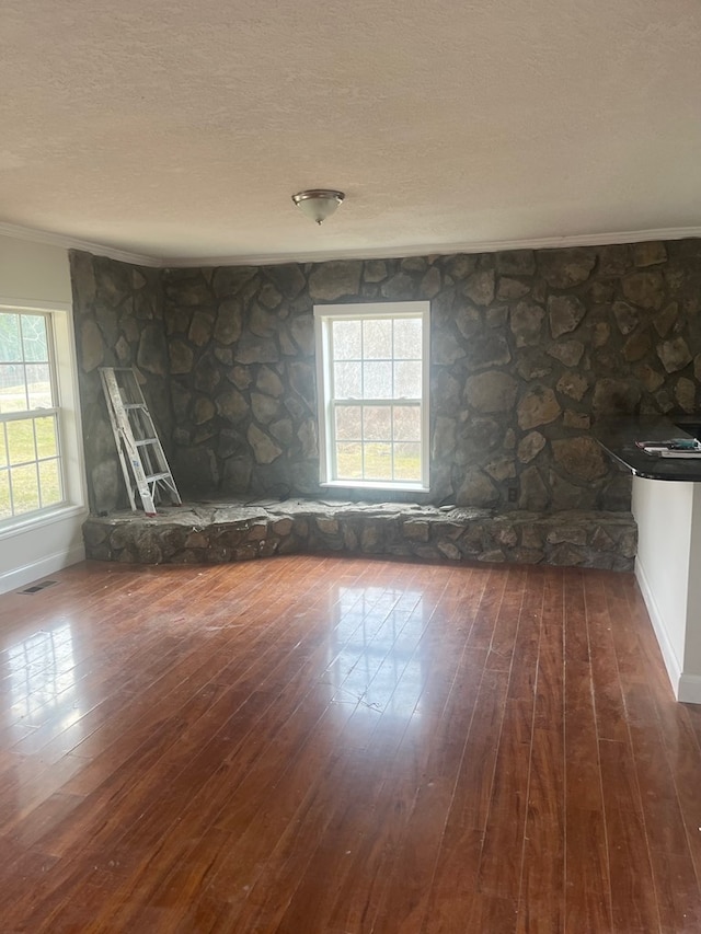 unfurnished room with ornamental molding, dark hardwood / wood-style floors, and a textured ceiling