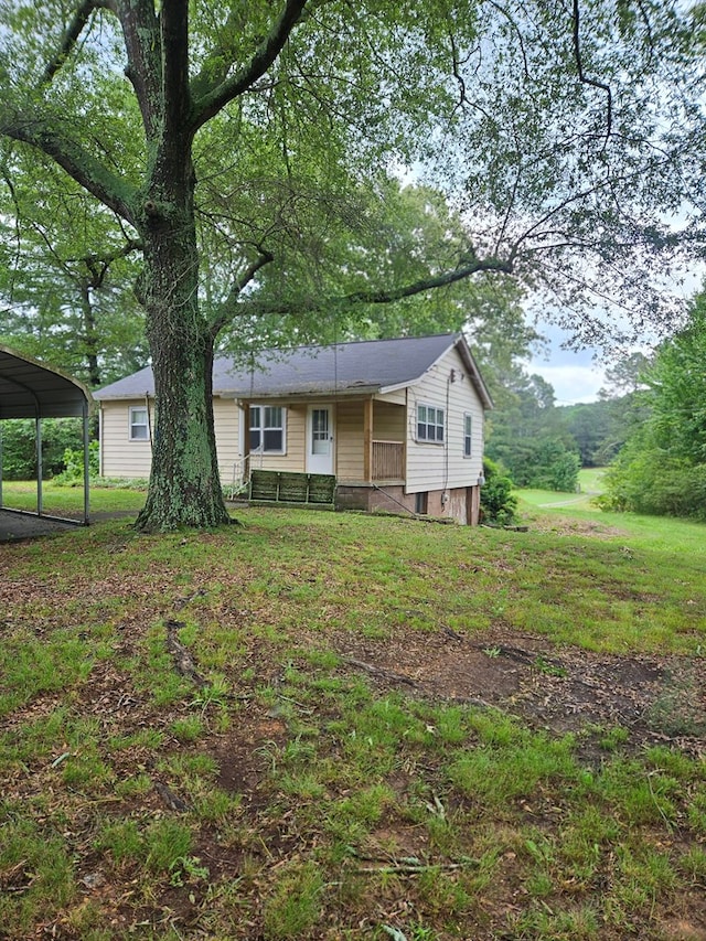 3165 Mcdaniel Station Rd, Adairsville, GA 30103 - view of front of home featuring a porch, a detached carport, and a front yard