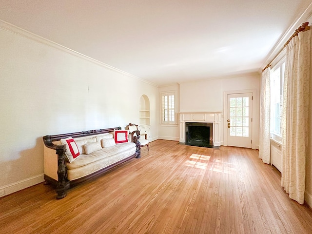 705 Greenwood Dr, Dalton, GA 30720 - living area with crown molding, arched walkways, a fireplace, baseboards, and light wood finished floors