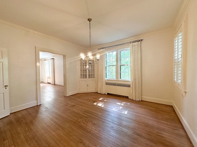 705 Greenwood Dr, Dalton, GA 30720 - unfurnished dining area with baseboards, ornamental molding, wood finished floors, and a chandelier