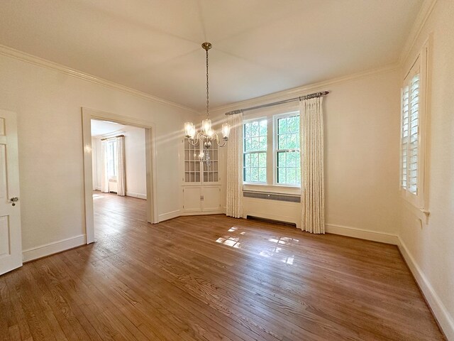 705 Greenwood Dr, Dalton, GA 30720 - unfurnished dining area with baseboards, ornamental molding, wood finished floors, and a chandelier