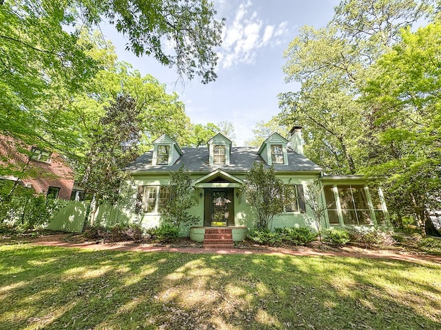705 Greenwood Dr, Dalton, GA 30720 - cape cod-style house with a chimney, a sunroom, and a front lawn