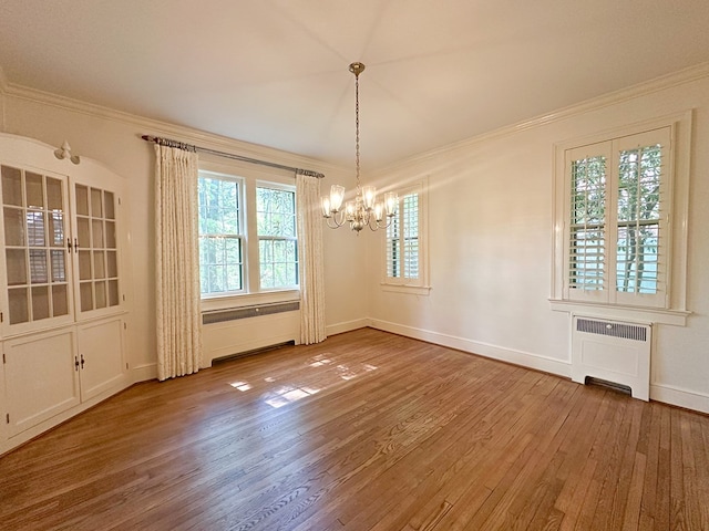 705 Greenwood Dr, Dalton, GA 30720 - unfurnished dining area featuring ornamental molding, wood finished floors, baseboards, radiator heating unit, and a chandelier