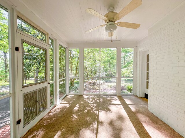 705 Greenwood Dr, Dalton, GA 30720 - unfurnished sunroom with brick wall and wood ceiling