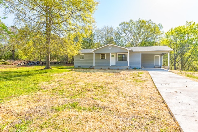 view of front facade with crawl space, a front lawn, a carport, and driveway