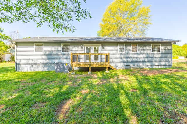 back of property with crawl space, a wooden deck, a yard, and central AC