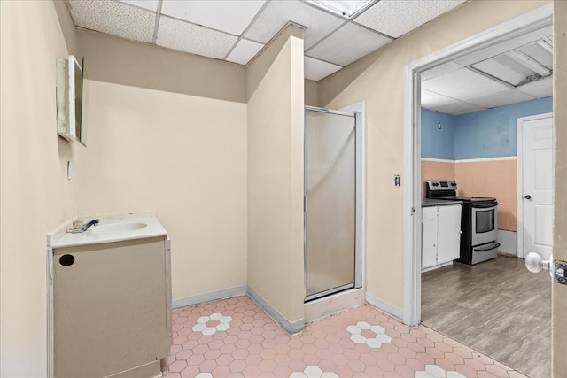 843 Mcafee St, Dalton, GA 30721 - bathroom featuring baseboards, vanity, tile patterned flooring, and a stall shower