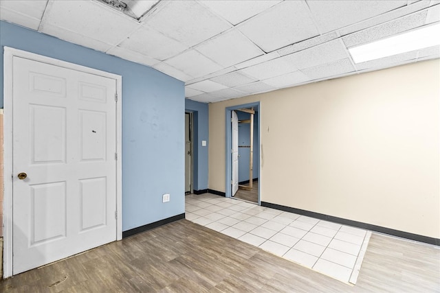 843 Mcafee St, Dalton, GA 30721 - spare room featuring wood finished floors, a drop ceiling, and baseboards