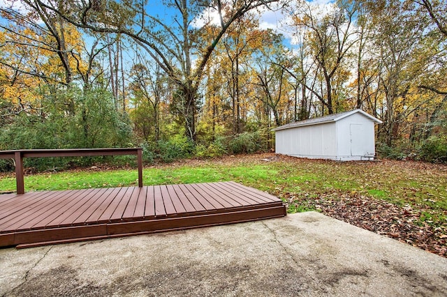 view of yard featuring a wooden deck and a storage shed