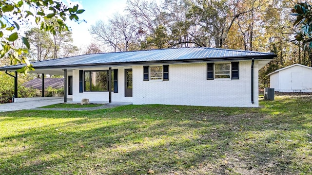 single story home with cooling unit, a carport, and a front lawn