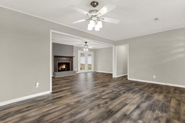 unfurnished living room with crown molding, dark hardwood / wood-style floors, ceiling fan, and a fireplace