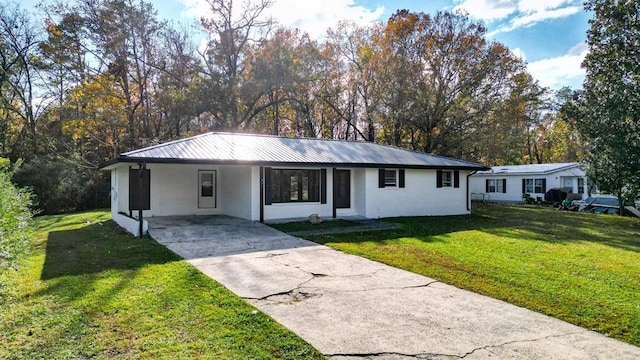 ranch-style house featuring a carport and a front lawn