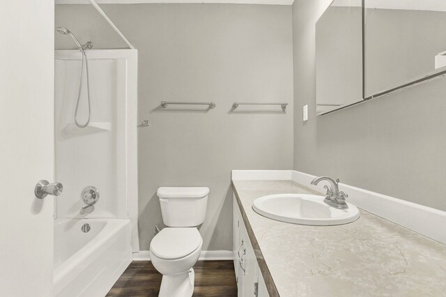 full bathroom with vanity, hardwood / wood-style flooring, shower / washtub combination, and toilet