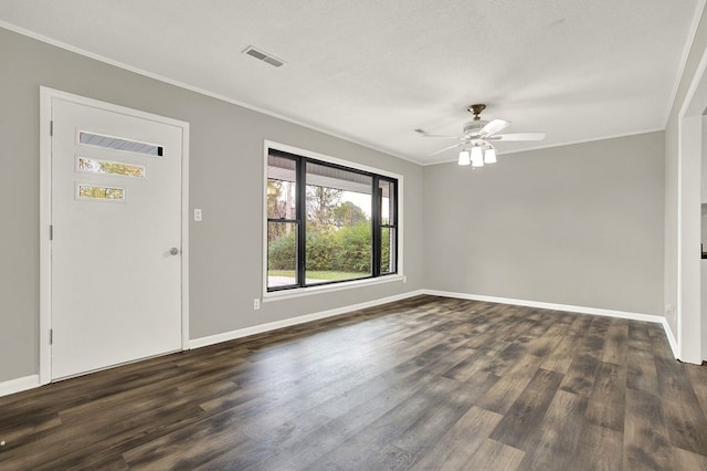 foyer entrance with dark wood-type flooring, ceiling fan, ornamental molding, and a textured ceiling