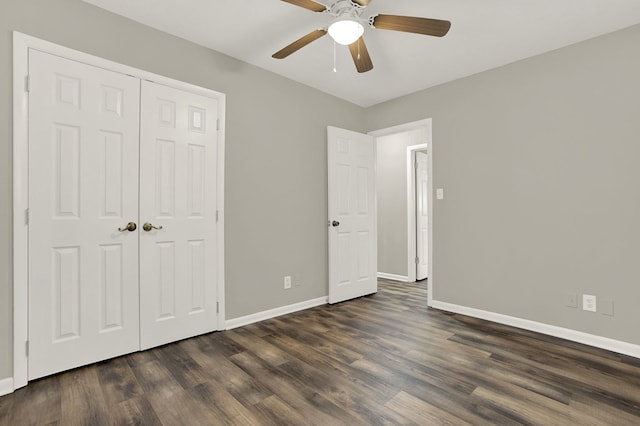 unfurnished bedroom featuring dark wood-type flooring, ceiling fan, and a closet