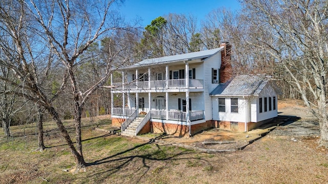 view of front of home featuring a balcony and a porch