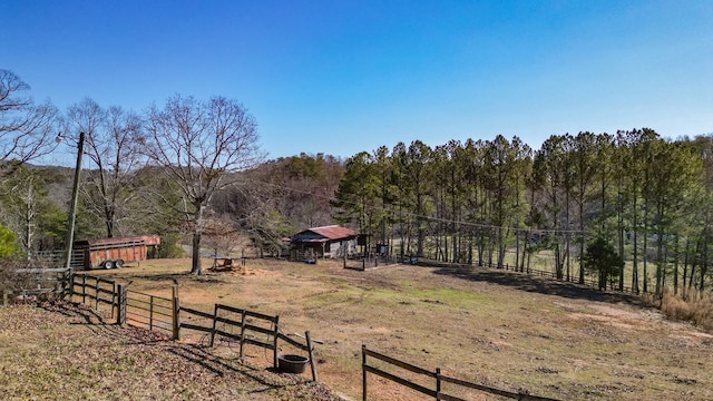 view of yard with an outbuilding and a rural view