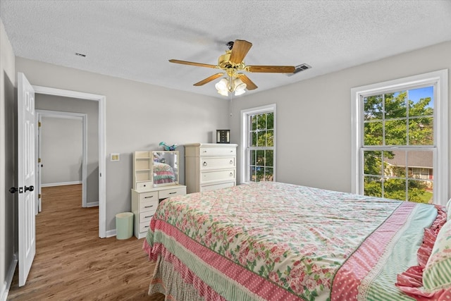 353 Diamond Way, Chatsworth, GA 30705 - bedroom with wood finished floors, a textured ceiling, and a ceiling fan