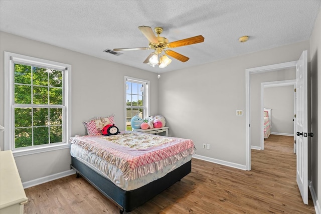 353 Diamond Way, Chatsworth, GA 30705 - bedroom featuring wood finished floors, a textured ceiling, and a ceiling fan