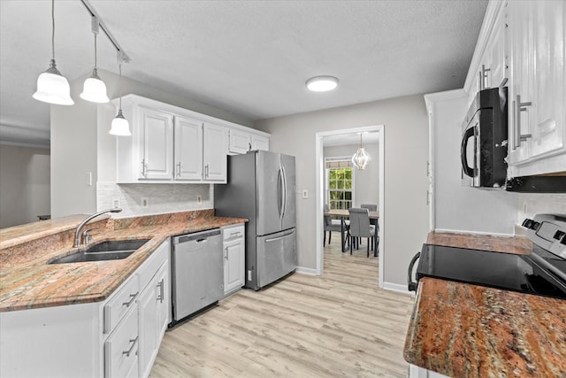 353 Diamond Way, Chatsworth, GA 30705 - kitchen featuring stainless steel appliances, white cabinets, light wood finished floors, a peninsula, and pendant lighting