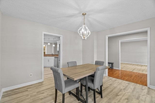 353 Diamond Way, Chatsworth, GA 30705 - dining room with light wood-type flooring and a chandelier