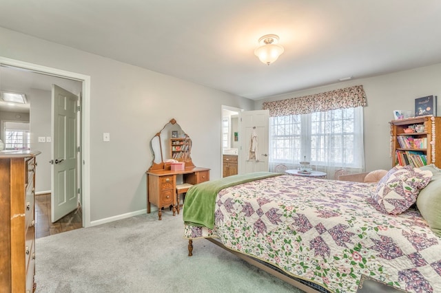 bedroom featuring light carpet and connected bathroom