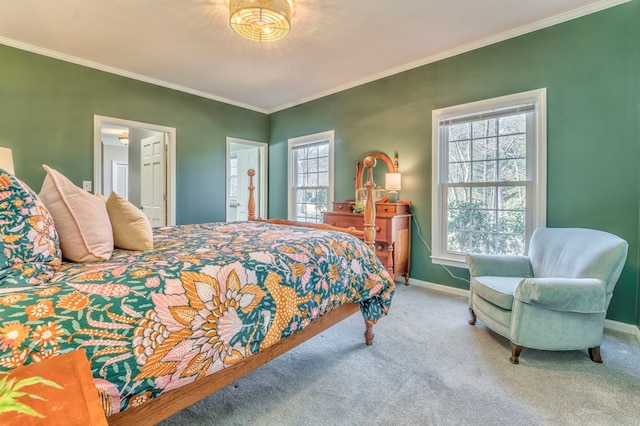 carpeted bedroom featuring ornamental molding and ensuite bathroom