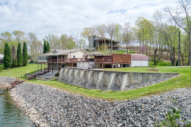 view of pool featuring a deck with water view and a yard
