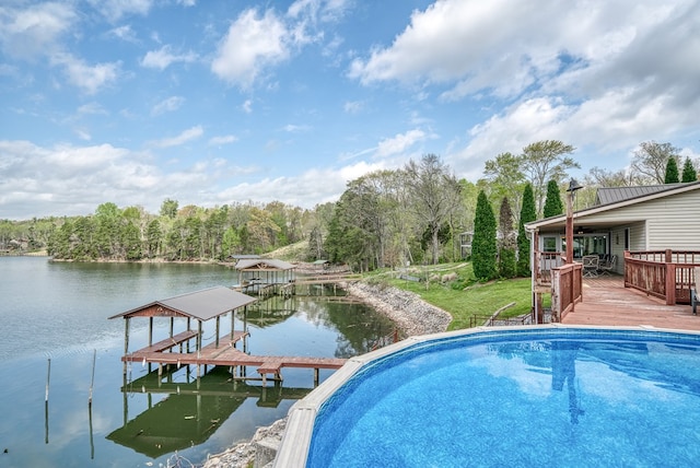 view of swimming pool featuring a deck with water view and a dock