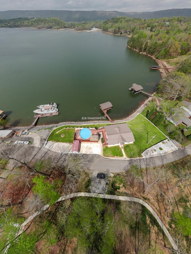 aerial view featuring a view of trees and a water view
