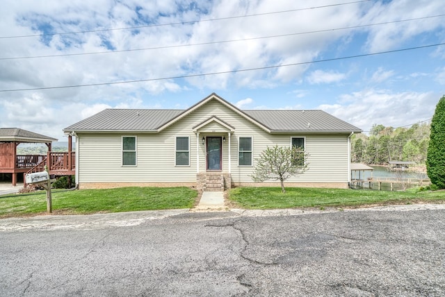 single story home featuring a gazebo, a front lawn, and metal roof