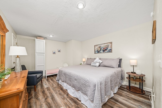 bedroom featuring recessed lighting, baseboards, a textured ceiling, and dark wood-style floors