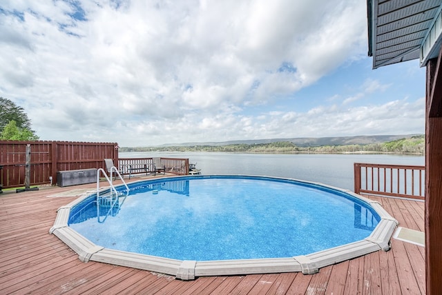 outdoor pool with a deck with water view