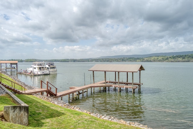 view of dock with boat lift and a water view