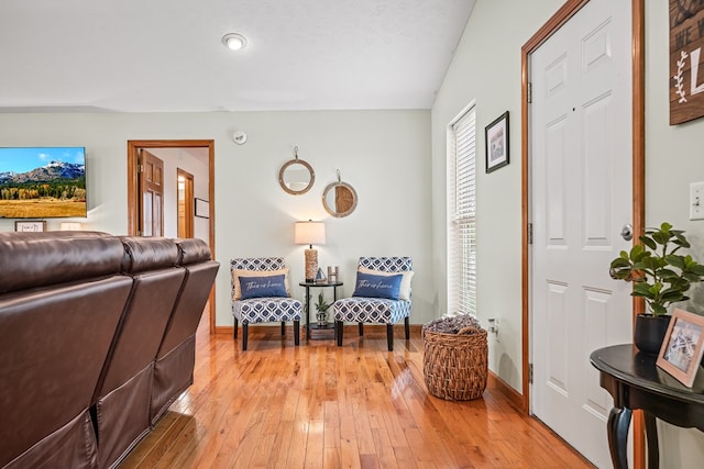 living room featuring baseboards and light wood-style flooring