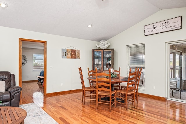 dining area with recessed lighting, vaulted ceiling, light wood-style flooring, and baseboards