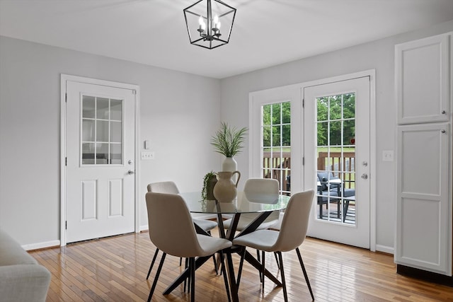 5742 Keith Rd, Ringgold, GA 30736 - dining area featuring baseboards, a chandelier, and light wood-style floors