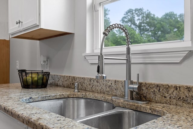 5742 Keith Rd, Ringgold, GA 30736 - interior details featuring a sink, light stone counters, and white cabinets