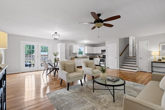 5742 Keith Rd, Ringgold, GA 30736 - living room with plenty of natural light, light wood-style flooring, ceiling fan, and stairway
