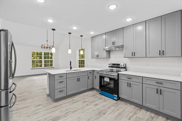 409 Van Buren Dr, Dalton, GA 30721 - kitchen with stainless steel appliances, gray cabinetry, a peninsula, under cabinet range hood, and light wood-style floors